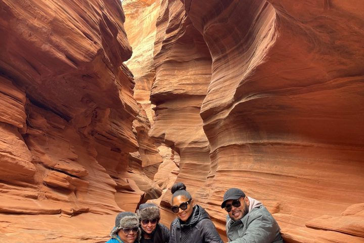 a group of people sitting at a canyon